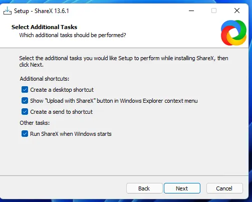 ShareX setup window titled 'Select Additional Tasks'. The window displays options for additional tasks during the installation of ShareX version 13.6.1. The options selected include: Create a desktop shortcut, Show 'Upload with ShareX' button in Windows Explorer context menu, Create a send to shortcut, and Run ShareX when Windows starts. The bottom of the window has 'Back', 'Next', and 'Cancel' buttons.